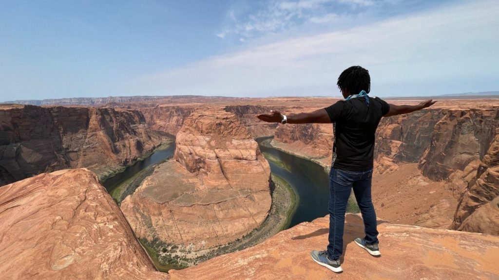 David standing at the edge of the rim overlooking Horseshoe Bend. 5 Things You will Love about Horseshoe Bend