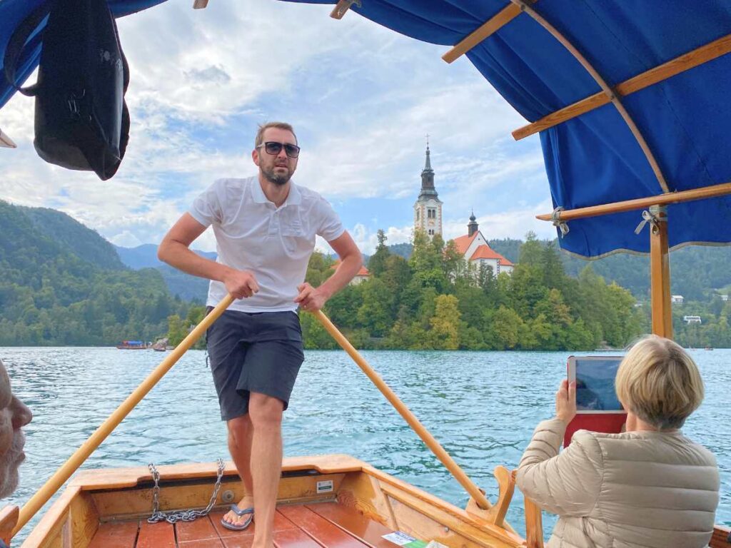 Pletna Boat captain rowing to Bled Island