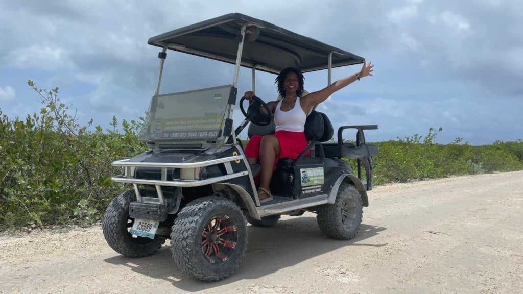 Kendra driving the golf cart on her our way to Secret Beach.