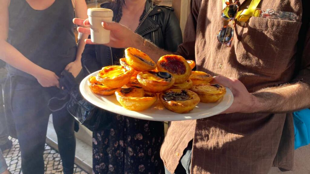 Trying Pastel de Nata on our Lisbon walking tour - a 4-day Lisbon Itinerary