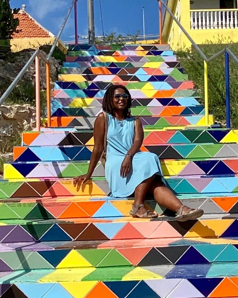 Kendra Lucas sitting on the colorful steps
