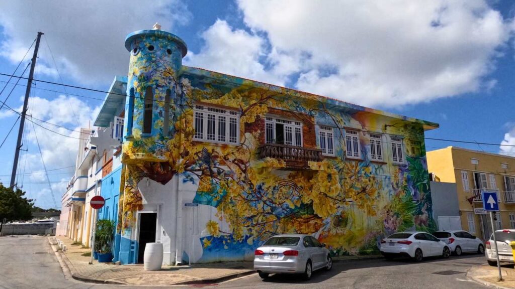 The colorful mural of blue and yellow on the Street Ark Skalo building