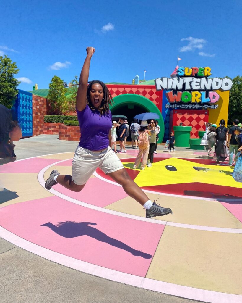 Kendra jumping like Mario at Super Nintendo World Osaka