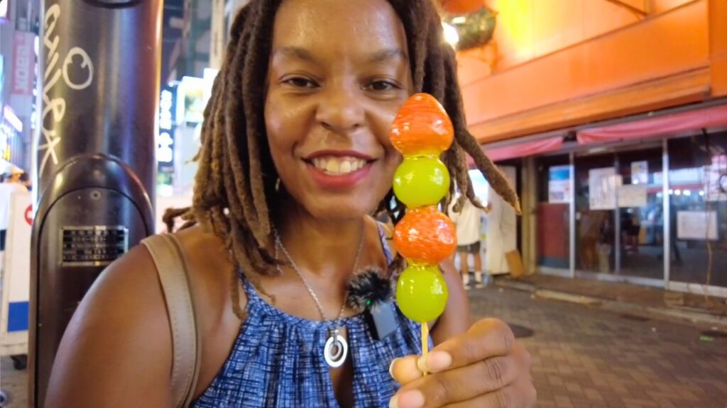 Kendra holding a strawberry tanghulu from Strawberry Mania Osaka
