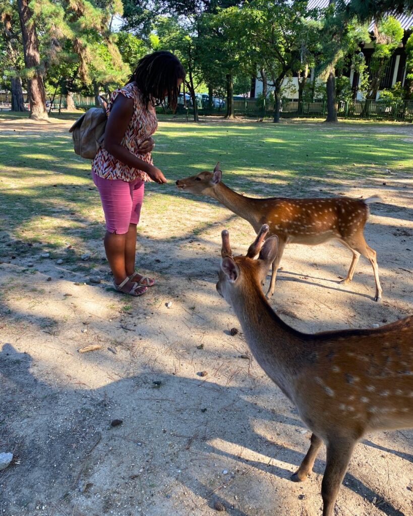 Kendra feeding two deers at Nara Deer Park Japan