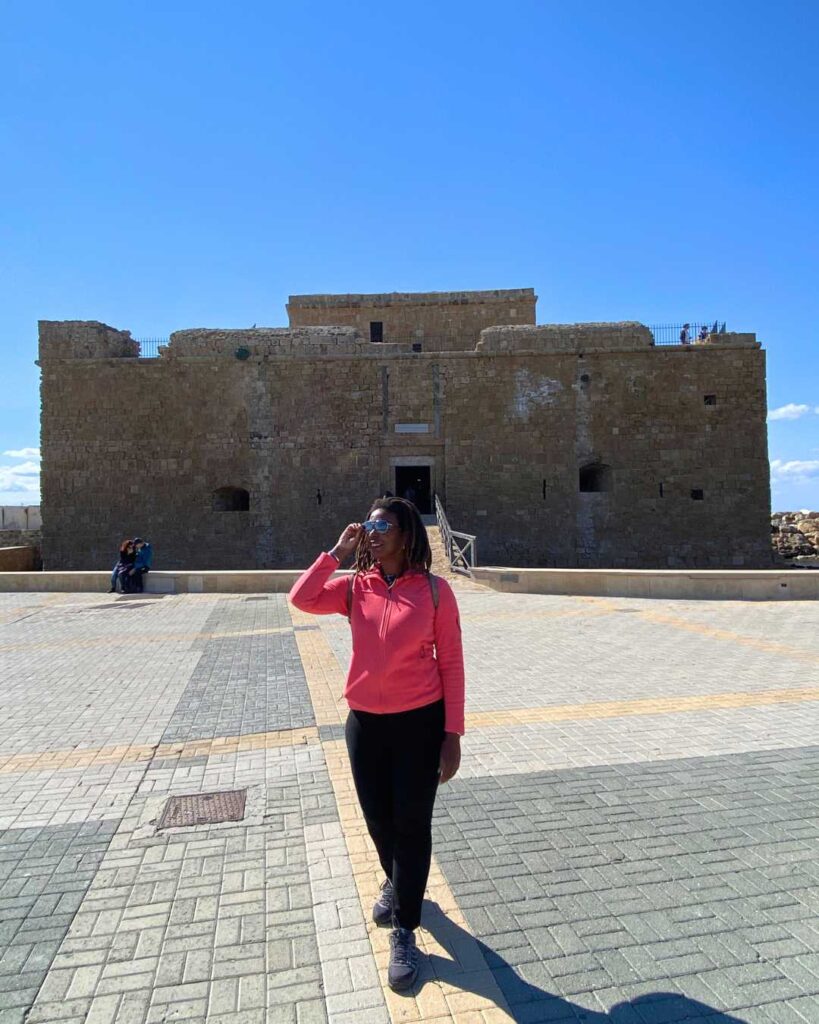 Kendra Lucas standing in front of Paphos Castle